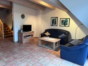 a living room with two couches and a table at FeWo Heinz in Fehmarn