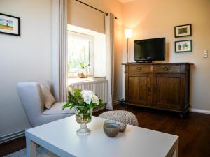 a living room with a vase of flowers on a table at Ferienwohnung Küthe in Fehmarn