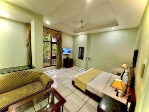 a bedroom with two beds and a tv in it at Hotel Florence Inn, Karol Bagh, New Delhi, 2 Min from Metro in New Delhi