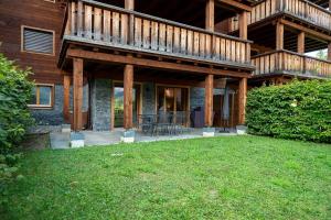 a house with a deck and a lawn in front of it at Terra Nostra A03 in Gryon +12 photos