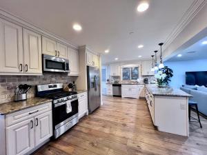 a kitchen with white cabinets and a counter top at Destination #28 in Anaheim