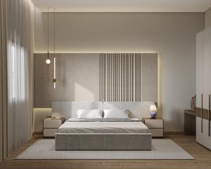 a bedroom with a king sized bed and two night stands at Liora Al Yasmin District in Riyadh
