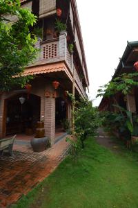 a building with a balcony on the side of it at Thusan House - Mekong Homestay in Ấp Vĩnh An (1)