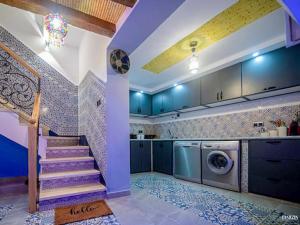 a kitchen with a staircase and a washing machine at Casa Barhoun in Chefchaouen