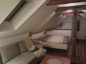 a living room with a couch and a bed at House in nature in Broby