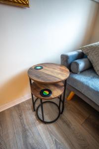 a table in a living room next to a couch at Anderson Apartment in Airdrie