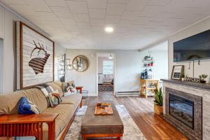 a living room with a couch and a fireplace at 3 Bears Cabin in Maggie Valley