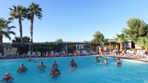 a group of people in a swimming pool at Happy Camp mobile homes in Kamemi Village in Seccagrande