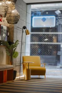 a yellow chair and a table in a room at Select Bilbao in Bilbao