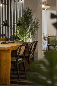 a wooden table with chairs and a plant at Select Bilbao in Bilbao