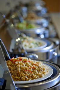 a row of plates of food on a table at Amaris Hotel Setiabudhi - Bandung in Bandung