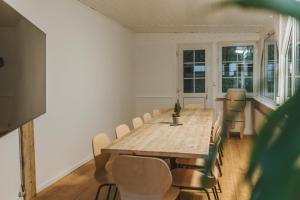 a dining room with a wooden table and chairs at Waldtraum Lodge Winterberg für 10 Personen mit Garten und Grill in Winterberg +14 photos