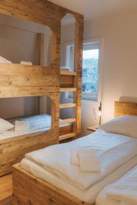 a bedroom with two bunk beds and a window at Ferienhaus Waldtraum Winterberg in Winterberg