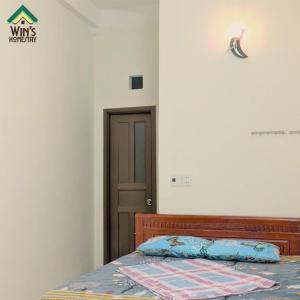 a bedroom with a bed and a door at Win's Homestay in Danang