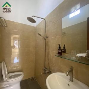a bathroom with a sink and a toilet and a mirror at Win's Homestay in Danang +12 photos
