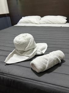 two towels sitting on top of a bed at hotel santa teresita in Santa Teresita +8 photos