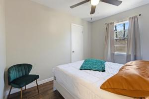 a bedroom with a bed and a chair and a window at Farmhouse Retreat in Bryan +14 photos