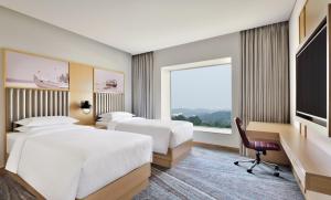 Letto o letti in una camera di Four Points by Sheraton Kochi Infopark