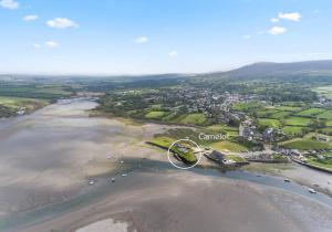 an aerial view of the shoreline of a beach at Camelot, Newport - A Pembrokeshire Waterside Cottage in Newport Pembrokeshire