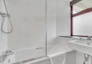 a white bathroom with a shower and a sink at Camelot, Newport - A Pembrokeshire Waterside Cottage in Newport Pembrokeshire +18 photos