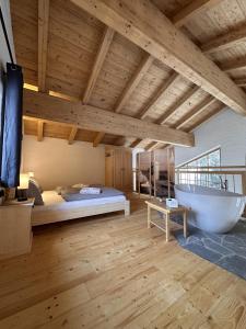 a bedroom with a bed and a bath tub in it at Chalet am Bachl 1 in Flattach