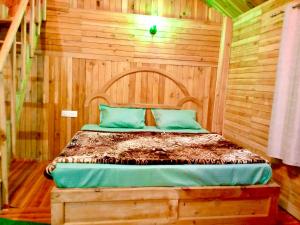 a wooden bedroom with a bed in a room at woodland duplex cottage 2 Jibhi in Jibhi +5 photos