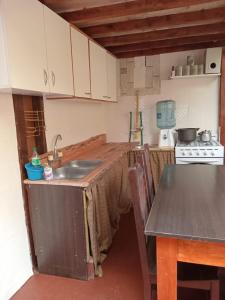 a kitchen with a table and a sink in it at El Isleño in Ushuaia