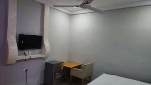 a small room with a small table and a television at Jakara Avenue Hotel- Tamale in Kyanshiogo +19 photos