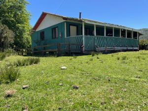 a green house sitting on top of a field at Cabaña de Campo in San José de la Mariquina