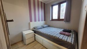 Postel nebo postele na pokoji v ubytování Wrzosowe Wzgórze Apartamenty