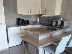a kitchen with white cabinets and a counter top at Ferienwohnung Sander mit Innenpool in Möhnesee