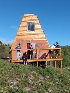 a group of people standing outside of a house at Ventana al Champaqui in Yacanto