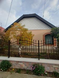 a black fence in front of a house at Bundik Vendégház in Berettyóújfalu