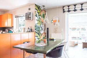 a kitchen with a table and a dining room at Designers apartment in Galatsi area in Athens