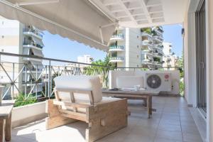 a balcony with a desk and a computer on it at Designers apartment in Galatsi area in Athens