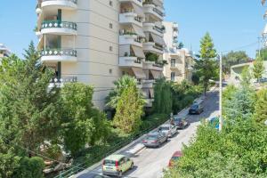 an apartment building with cars parked on a street at Designers apartment in Galatsi area in Athens