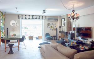 a living room with a couch and a table at Designers apartment in Galatsi area in Athens
