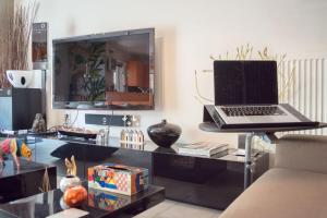 a desk with a laptop on top of it at Designers apartment in Galatsi area in Athens +18 photos
