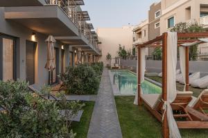 an apartment with a swimming pool in a building at NEK Suites - Adults Only in Chania Town +37 photos