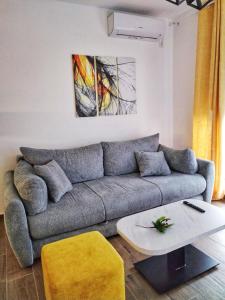 a living room with a couch and a table at Moj Mir in Vrnjačka Banja