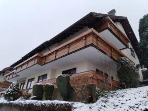 a building with snow on the ground in front of it at Naturblick in Baiersbronn