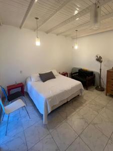 a bedroom with a bed and a chair and a fan at Puyuta beach in Rivadavia +13 photos