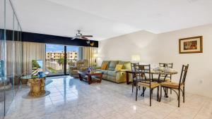 a living room with a couch and a table at Relaxing Ocean Condo Steps from the Beach in Daytona Beach Shores