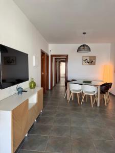 a kitchen and dining room with a table and chairs at Lovely Casa Deseada, heated pool, jacuzzi, BBQ, ping pong table in Playa Blanca