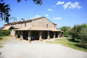 a large brick house with a driveway in front of it at Montepozzalino in Massa Marittima