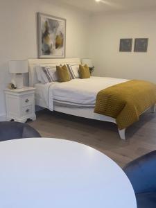 a bedroom with a large bed with a yellow blanket at Watermark Luxury Accommodation in Portmagee +6 photos