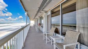 a balcony with chairs and a view of the ocean at Daytona Beach Getaway with Direct Ocean Views in Daytona Beach +9 photos