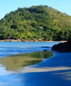 an island in the middle of a body of water at Kitnets da Lu in Ubatuba