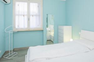 a bedroom with a white bed and a window at Apartment Alba Gardena in Bardolino +15 photos