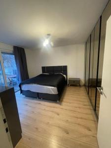 a bedroom with a bed and a wooden floor at Big Apartment in Bochum in Bochum